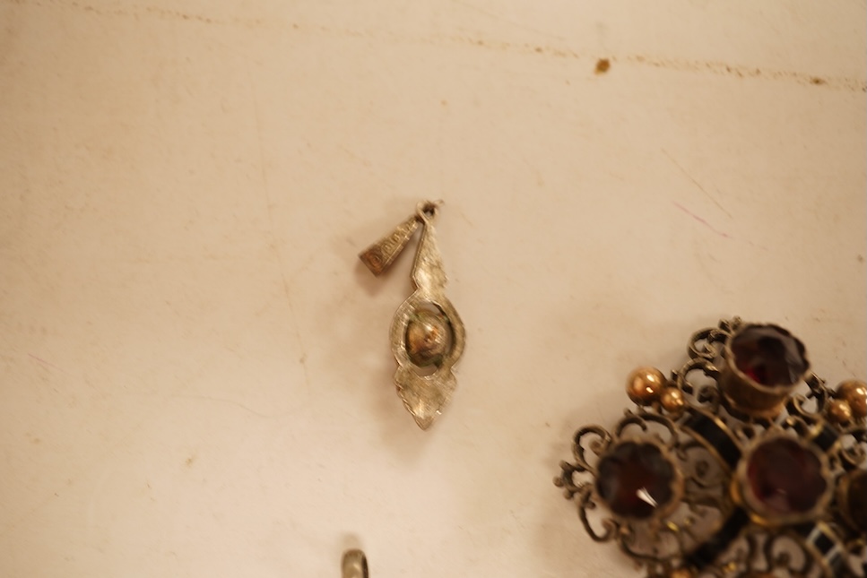 A late 19th/early 20th century Viennese pierced white metal, enamel and garnet cluster set brooch, 34mm, together with four other items of paste set jewellery.